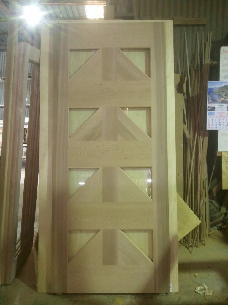 Front door with triangle glass panels, as per clients design.