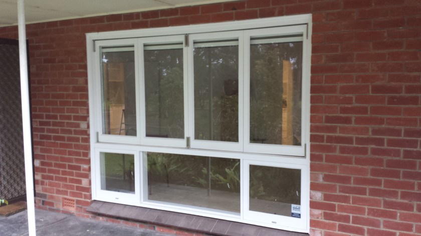 Timber bifold window painted white