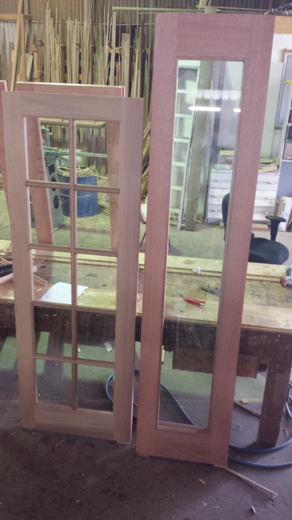 2 doors. 1 a standard height door with colonial bars. The other an extra tall and thin full glass door.