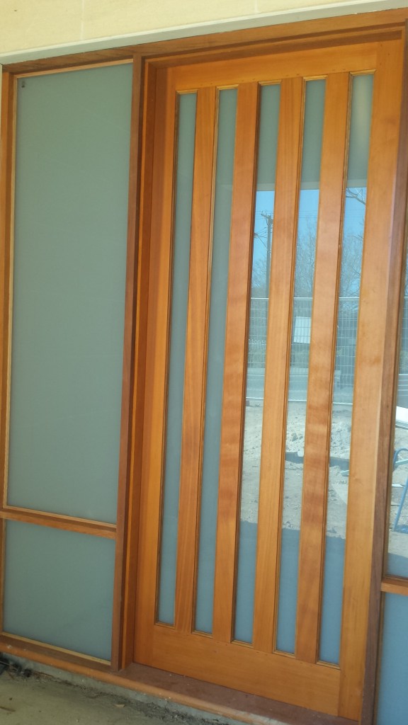 Western red cedar front door. white trans lam glass. door frame with sidelites + hardwood sill.