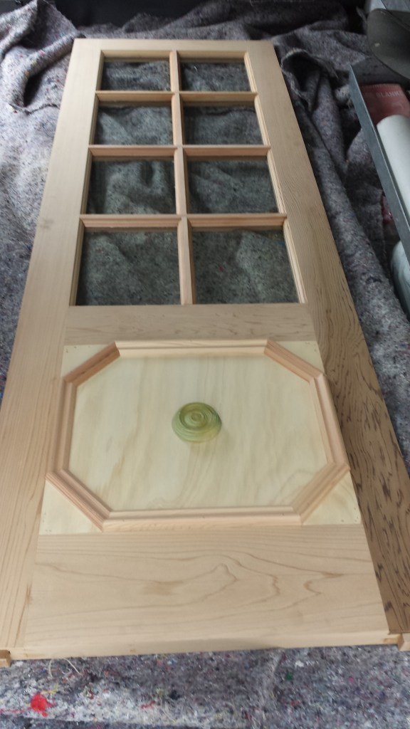 Timber door with colonial bars, kick panel with bolection moulding and rosette