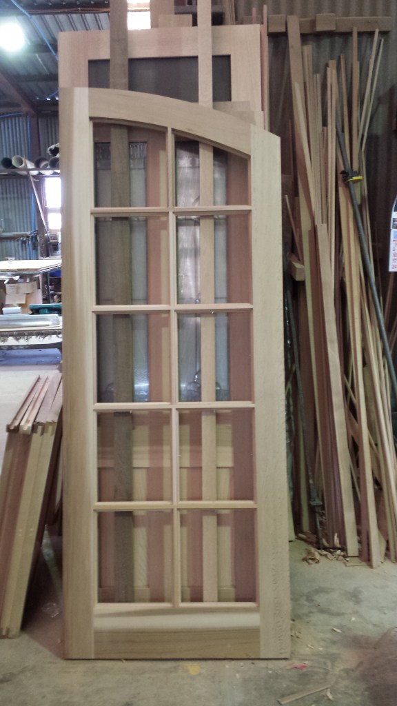 Arched WRC door with colonial bars. 1 of 2. unglazed.