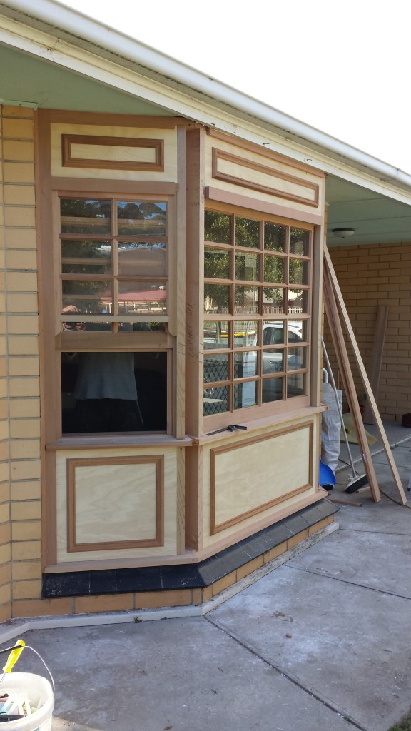 WRC bay window with colonial bars, and timber paneling.  Involved removing existing bay window.
