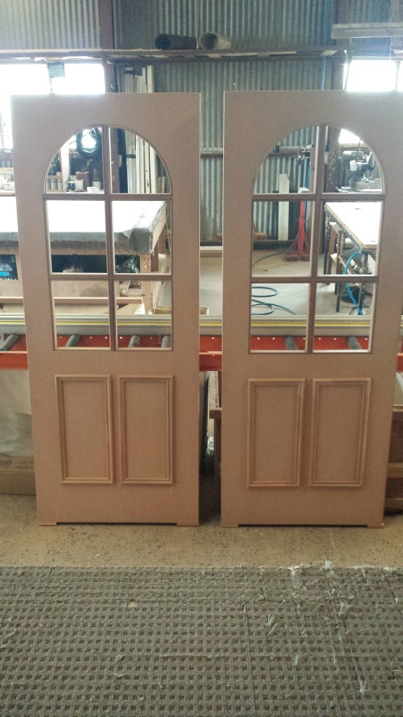Solid doors with colonial bars and arched glass. unglazed.