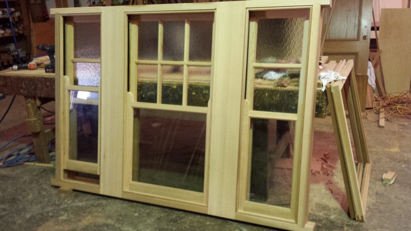 WRC lift up window with clear glass on bottom sashes, and cathedral glass on top.