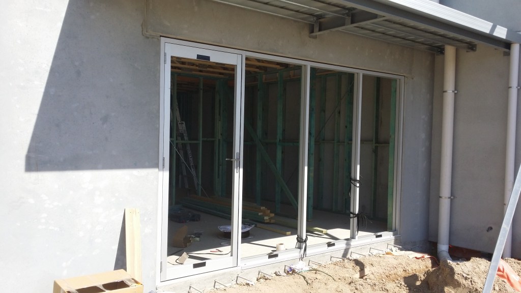 Clear Anodise series 400 commercial framing with hinged door.  