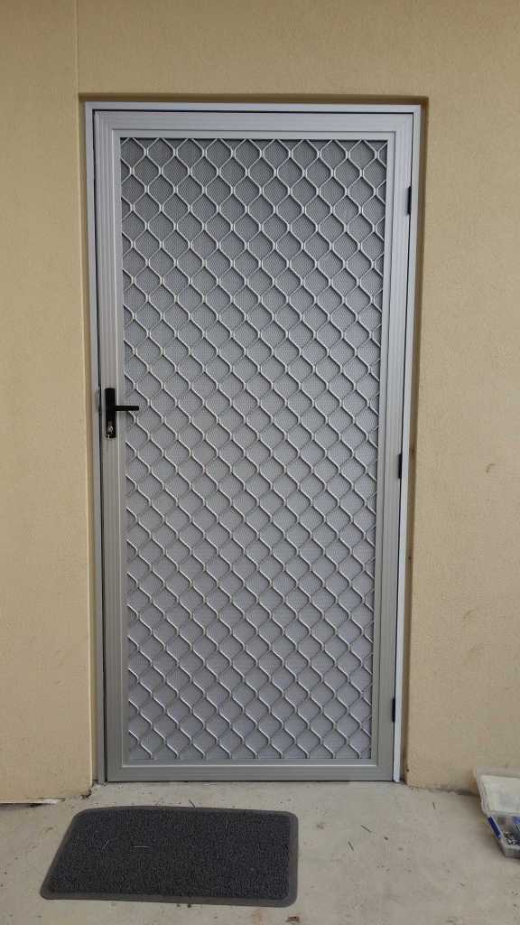 Clear anodise security door with 007 diamond grille and DVA restricted vision mesh.